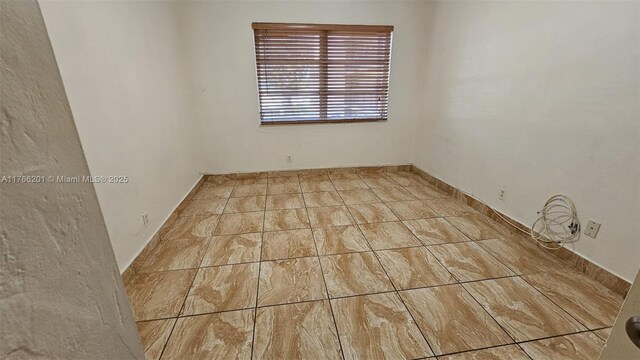 13715 Kendale Lakes Cir Unit A-201, Miami, FL 33183 - spare room with baseboards