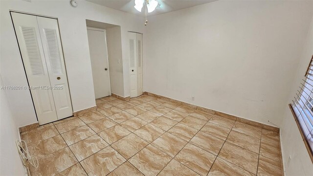 13715 Kendale Lakes Cir Unit A-201, Miami, FL 33183 - unfurnished bedroom featuring two closets