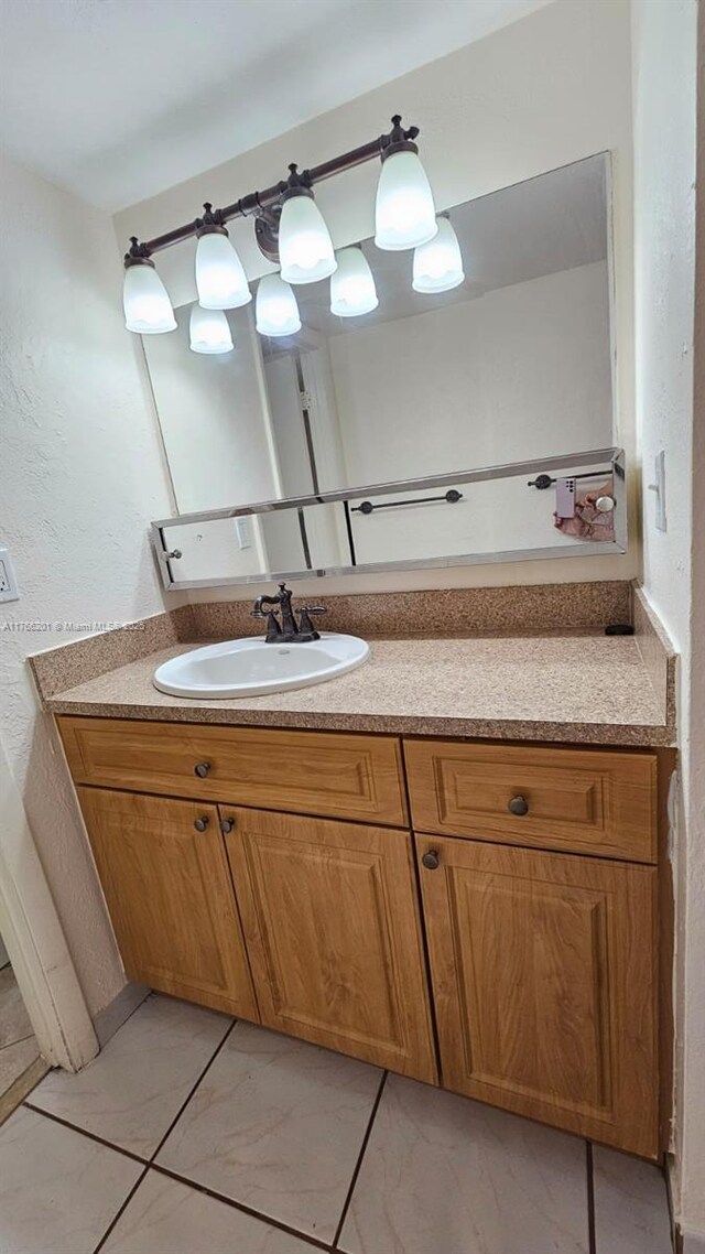 13715 Kendale Lakes Cir Unit A-201, Miami, FL 33183 - bathroom featuring vanity, marble look tile flooring, and a textured wall