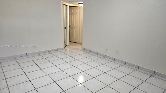 13715 Kendale Lakes Cir Unit A-201, Miami, FL 33183 - empty room featuring light tile patterned floors and baseboards