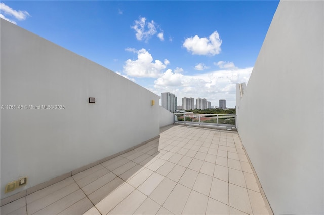 view of patio / terrace with a balcony and a view of city