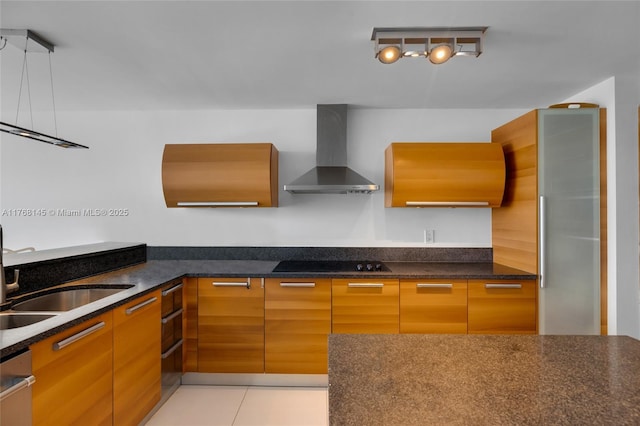 kitchen with light tile patterned floors, a sink, black electric stovetop, wall chimney exhaust hood, and modern cabinets