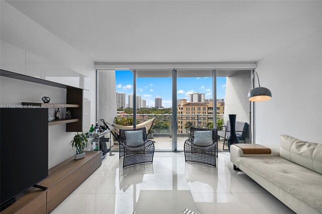 living room with a city view, floor to ceiling windows, and tile patterned flooring