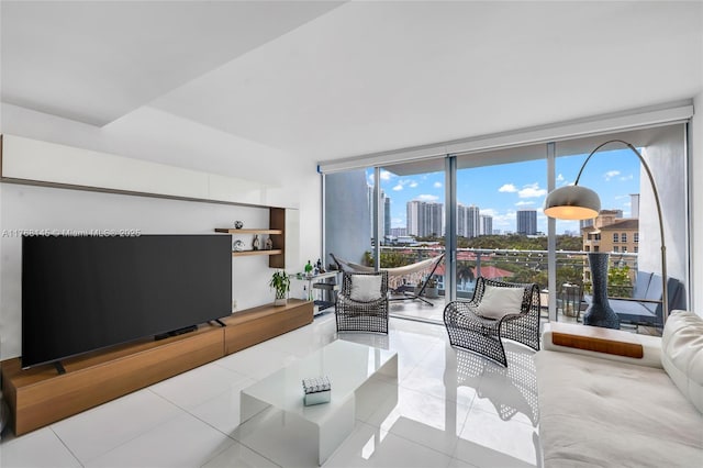 living room with tile patterned flooring, a view of city, and expansive windows