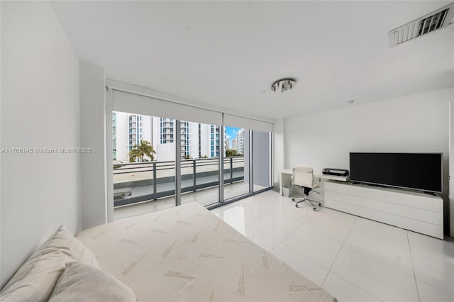bedroom featuring tile patterned flooring, a wall of windows, access to outside, and visible vents