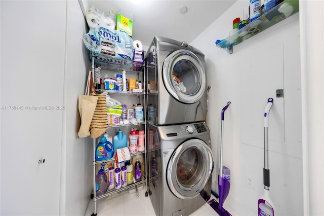 laundry area with laundry area, stacked washer and dryer, and tile patterned floors