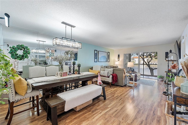 12901 SW 15th Ct Unit 208V, Pembroke Pines, FL 33027 - dining room with a textured ceiling and wood finished floors