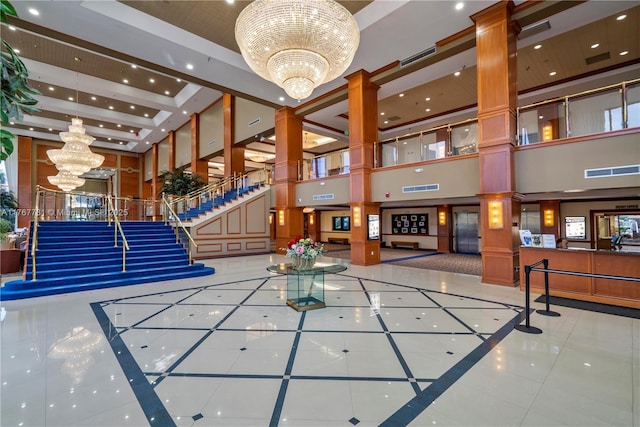 12901 SW 15th Ct Unit 208V, Pembroke Pines, FL 33027 - community lobby featuring a towering ceiling, recessed lighting, and stairs