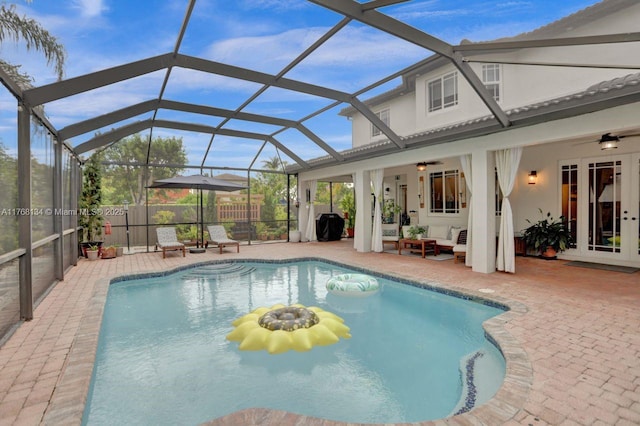 view of pool with a patio area, french doors, a lanai, and a ceiling fan