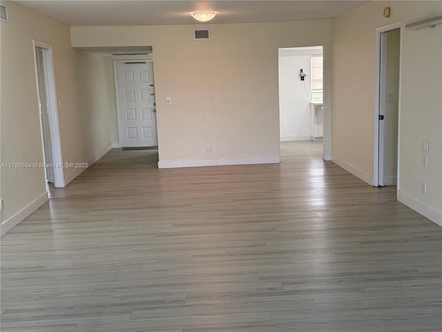 804 Cypress Blvd Unit 407, Pompano Beach, FL 33069 - empty room with baseboards and light wood-style floors