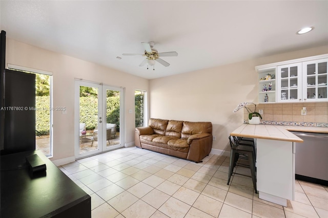 living area featuring baseboards, ceiling fan, recessed lighting, french doors, and light tile patterned flooring
