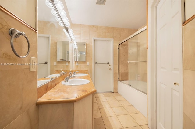 full bath featuring a sink, tile walls, and tile patterned flooring