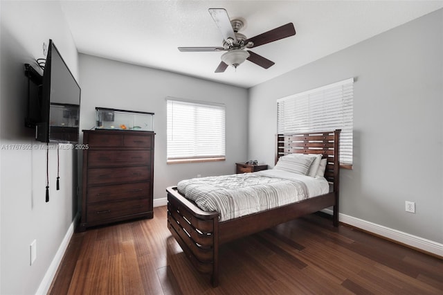 bedroom featuring ceiling fan, baseboards, and wood finished floors
