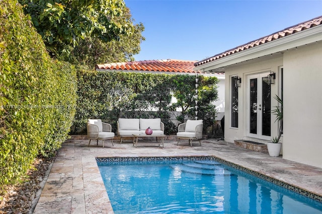 view of pool with a patio area, french doors, a fenced backyard, and an outdoor hangout area