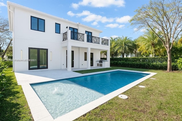 2523 Red Rd, Coral Gables, FL 33134 - rear view of property featuring a balcony, a yard, stucco siding, a patio area, and french doors