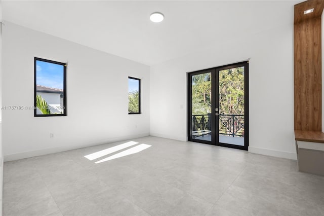 2523 Red Rd, Coral Gables, FL 33134 - spare room featuring plenty of natural light, baseboards, and french doors