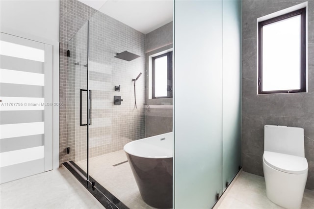 2523 Red Rd, Coral Gables, FL 33134 - bathroom featuring a stall shower, tile walls, a freestanding tub, and toilet