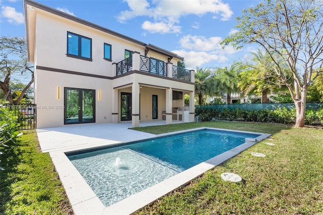 2523 Red Rd, Coral Gables, FL 33134 - rear view of house with a balcony, stucco siding, and a patio