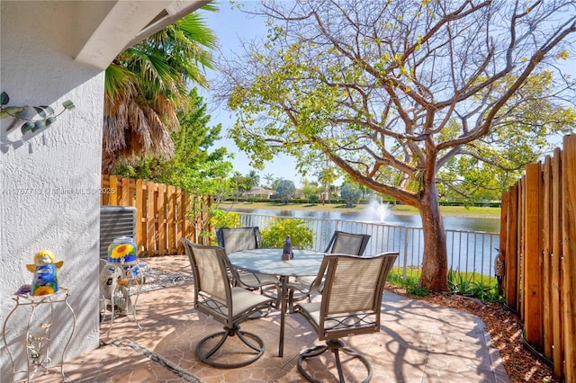 7807 NW 114th Pl, Doral, FL 33178 - view of patio / terrace with outdoor dining space, fence, and a water view