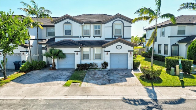 7807 NW 114th Pl, Doral, FL 33178 - view of front facade featuring stucco siding, a tile roof, decorative driveway, and a garage