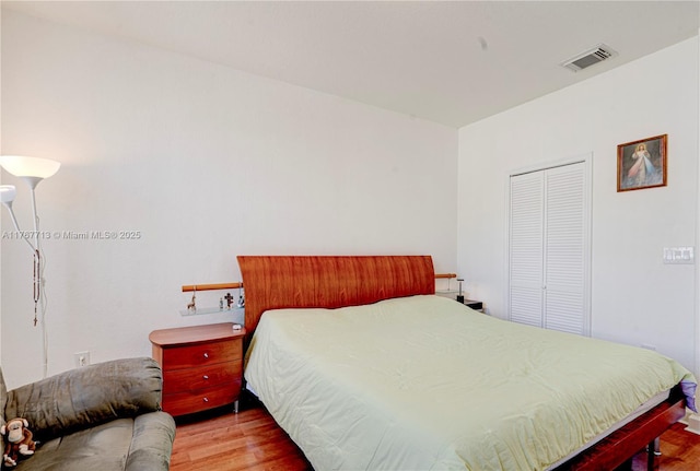 7807 NW 114th Pl, Doral, FL 33178 - bedroom featuring a closet, visible vents, and wood finished floors