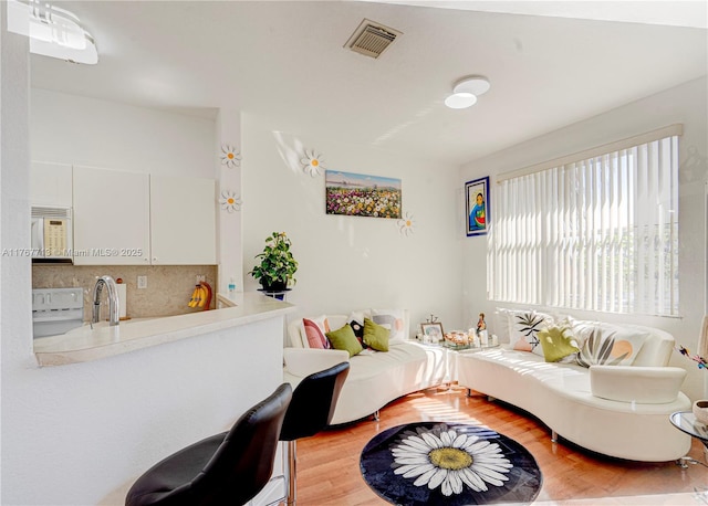 7807 NW 114th Pl, Doral, FL 33178 - living area with visible vents and light wood-style floors