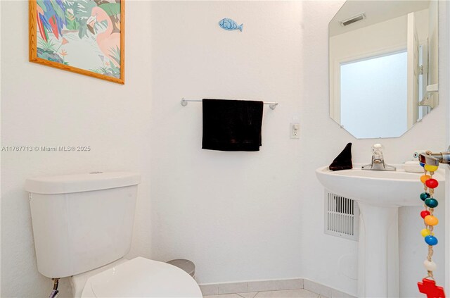 7807 NW 114th Pl, Doral, FL 33178 - bathroom with toilet, baseboards, and visible vents