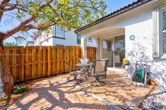 7807 NW 114th Pl, Doral, FL 33178 - view of patio / terrace with outdoor dining space and fence