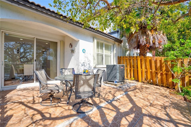 7807 NW 114th Pl, Doral, FL 33178 - view of patio / terrace featuring outdoor dining space, fence, and central AC