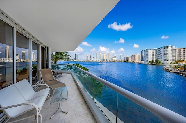 balcony with a water view and a city view