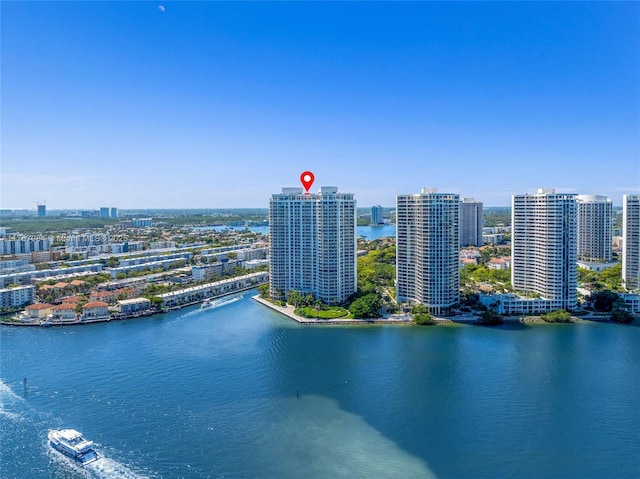 birds eye view of property with a view of city and a water view