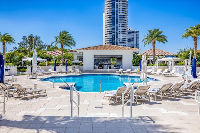 pool featuring a gazebo, fence, and a patio area