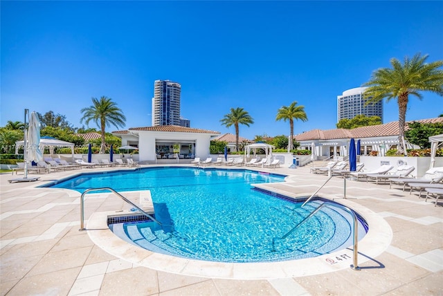 community pool featuring a gazebo, a pergola, and a patio