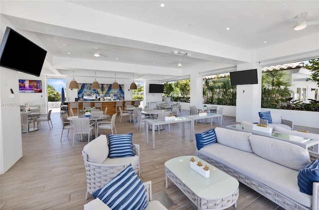 living area with recessed lighting, light wood-style flooring, and a ceiling fan