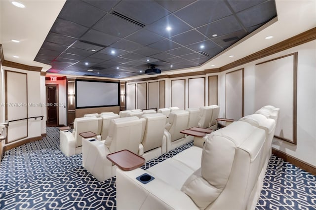 carpeted home theater with visible vents, recessed lighting, a decorative wall, and ornamental molding
