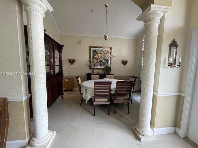 dining room with decorative columns, light tile patterned flooring, ornamental molding, and baseboards