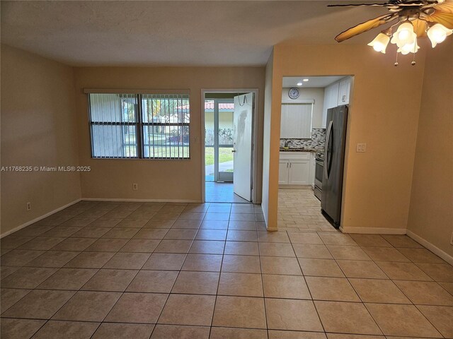 250 Layne Blvd Unit 105, Hallandale Beach, FL 33009 - unfurnished room featuring a ceiling fan, light tile patterned flooring, and baseboards