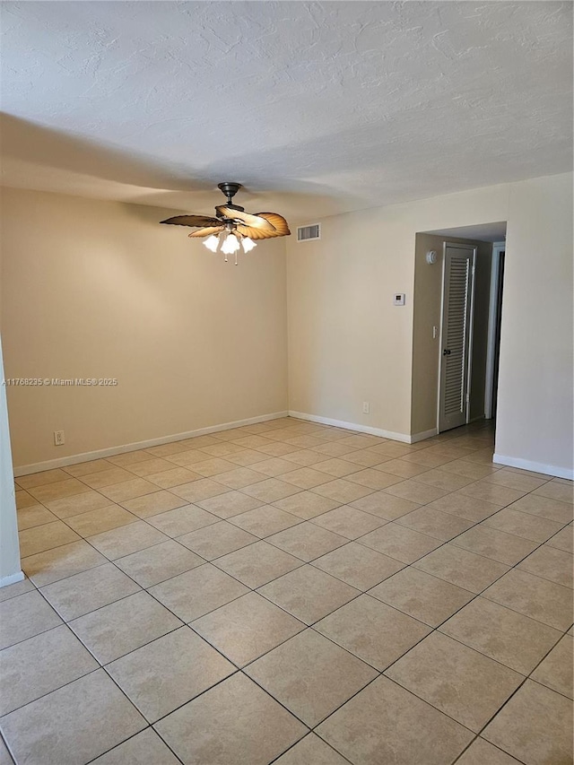 250 Layne Blvd Unit 105, Hallandale Beach, FL 33009 - empty room with a textured ceiling, visible vents, baseboards, a ceiling fan, and light tile patterned floors