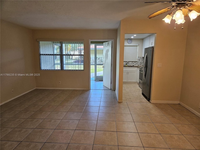 250 Layne Blvd Unit 105, Hallandale Beach, FL 33009 - unfurnished room featuring light tile patterned flooring, baseboards, and ceiling fan