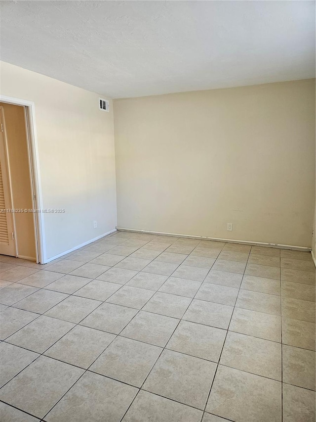250 Layne Blvd Unit 105, Hallandale Beach, FL 33009 - empty room with light tile patterned flooring, visible vents, and a textured ceiling