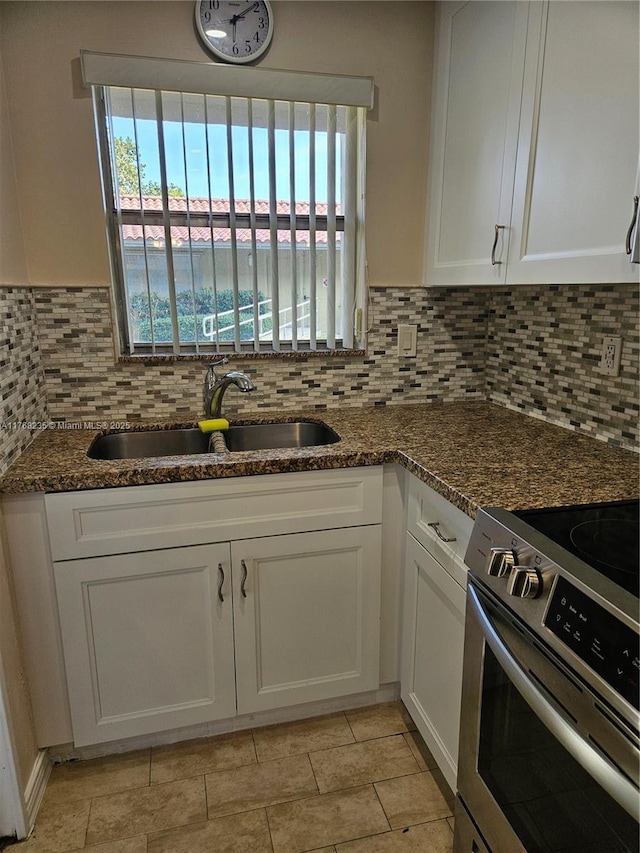 250 Layne Blvd Unit 105, Hallandale Beach, FL 33009 - kitchen featuring electric stove, white cabinets, a sink, and tasteful backsplash