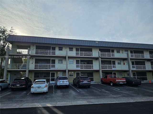 250 Layne Blvd Unit 105, Hallandale Beach, FL 33009 - view of building exterior featuring uncovered parking