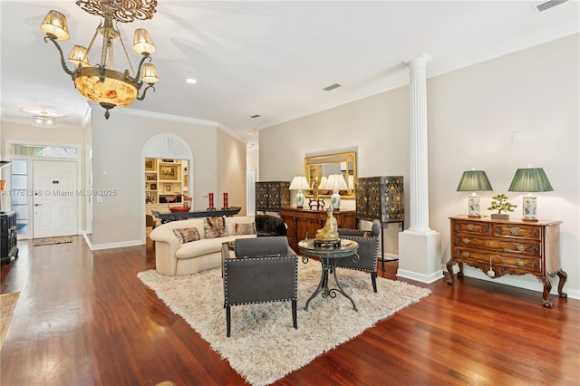 living room featuring ornate columns, crown molding, wood finished floors, baseboards, and recessed lighting