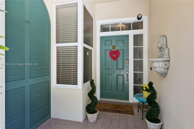 property entrance featuring stucco siding and covered porch