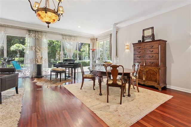 dining area featuring ornamental molding, wood finished floors, baseboards, recessed lighting, and decorative columns