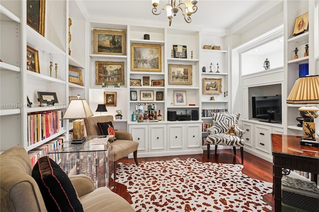 living area featuring a chandelier, crown molding, dark wood-style floors, and built in features