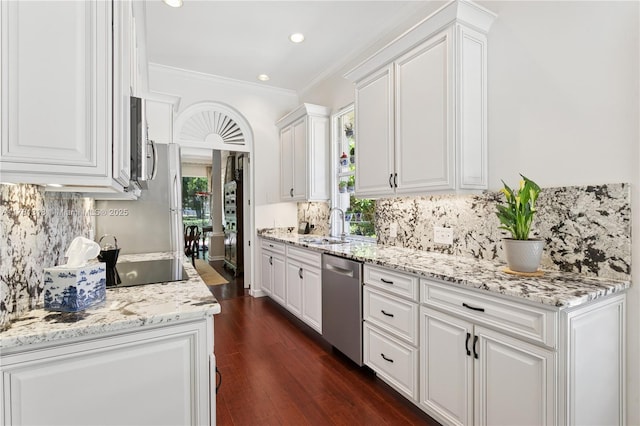 kitchen featuring dishwasher, a sink, white cabinets, recessed lighting, and ornamental molding
