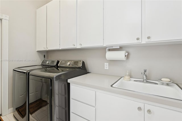 clothes washing area with cabinet space and washing machine and dryer