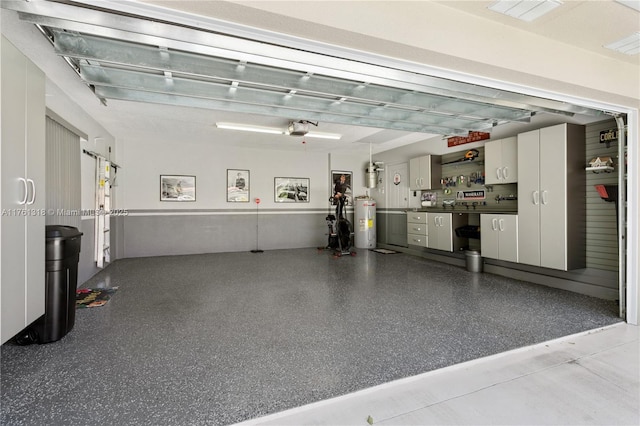 garage featuring water heater and a garage door opener