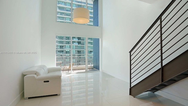 60 SW 13th St Unit 3820, Miami, FL 33130 - stairs featuring plenty of natural light, tile patterned floors, a high ceiling, and baseboards